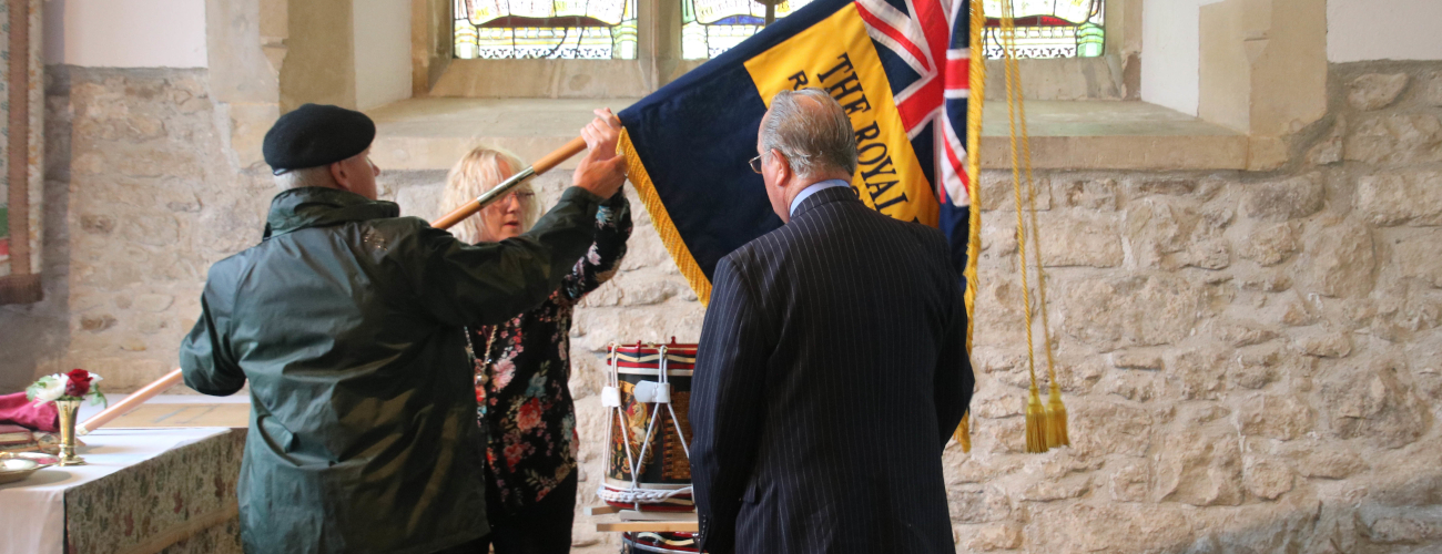 Rev Maria and two members of the British legion holding their flag